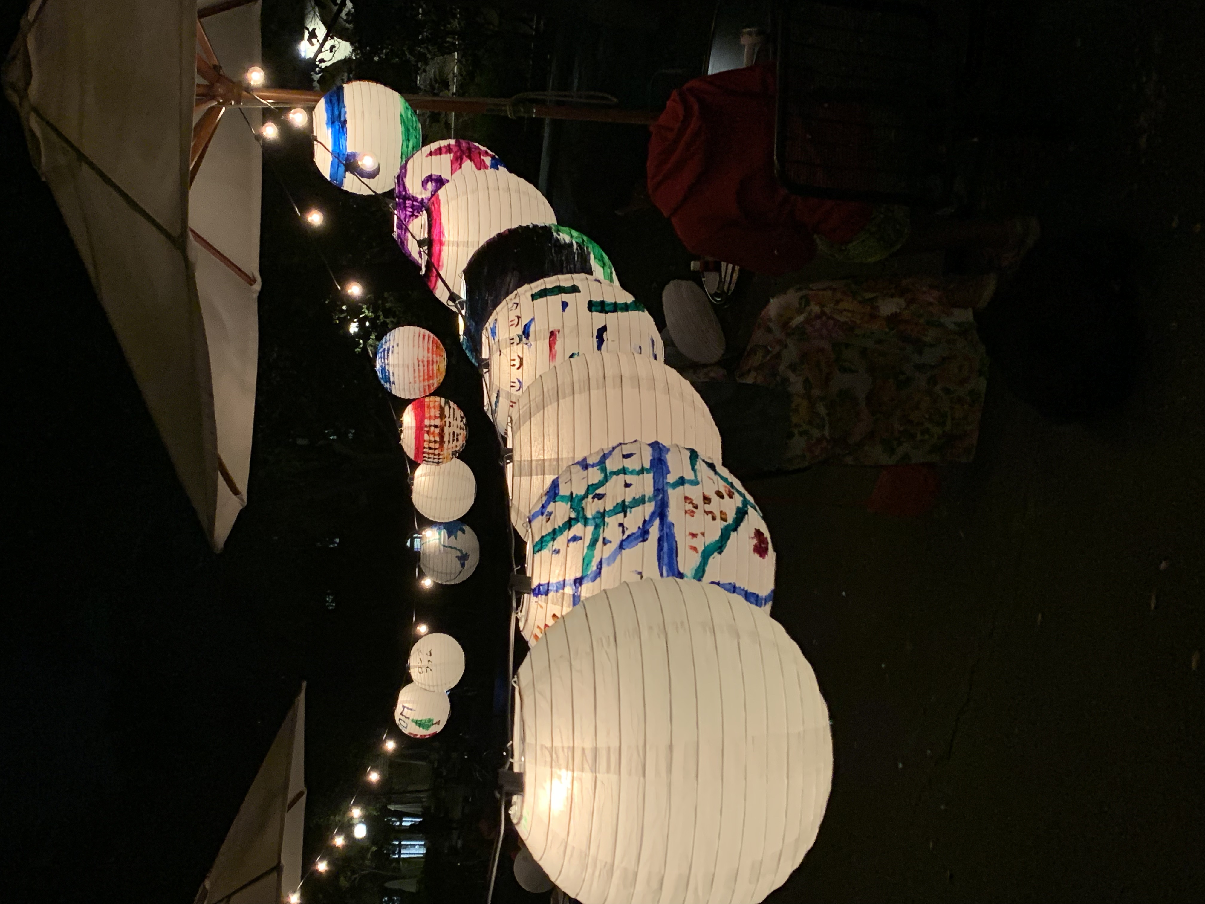 Image of decorated paper lanterns hooked on to and illuminated by a string of lights at SVSA's Lunar New Year event